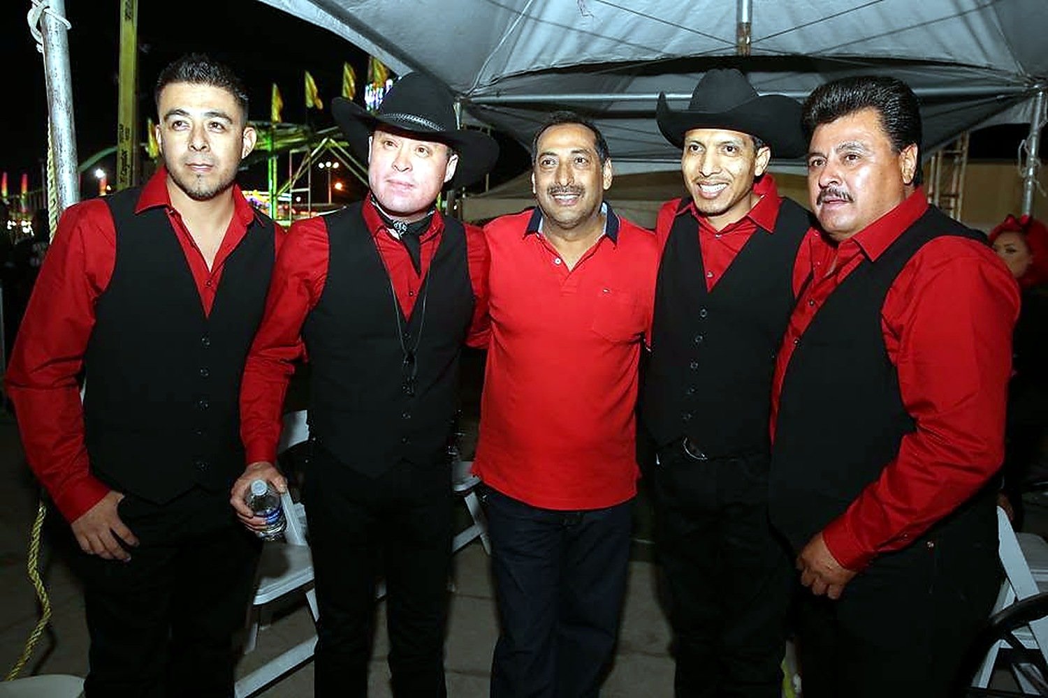 Grupo Silverado with band members and crew during a performance