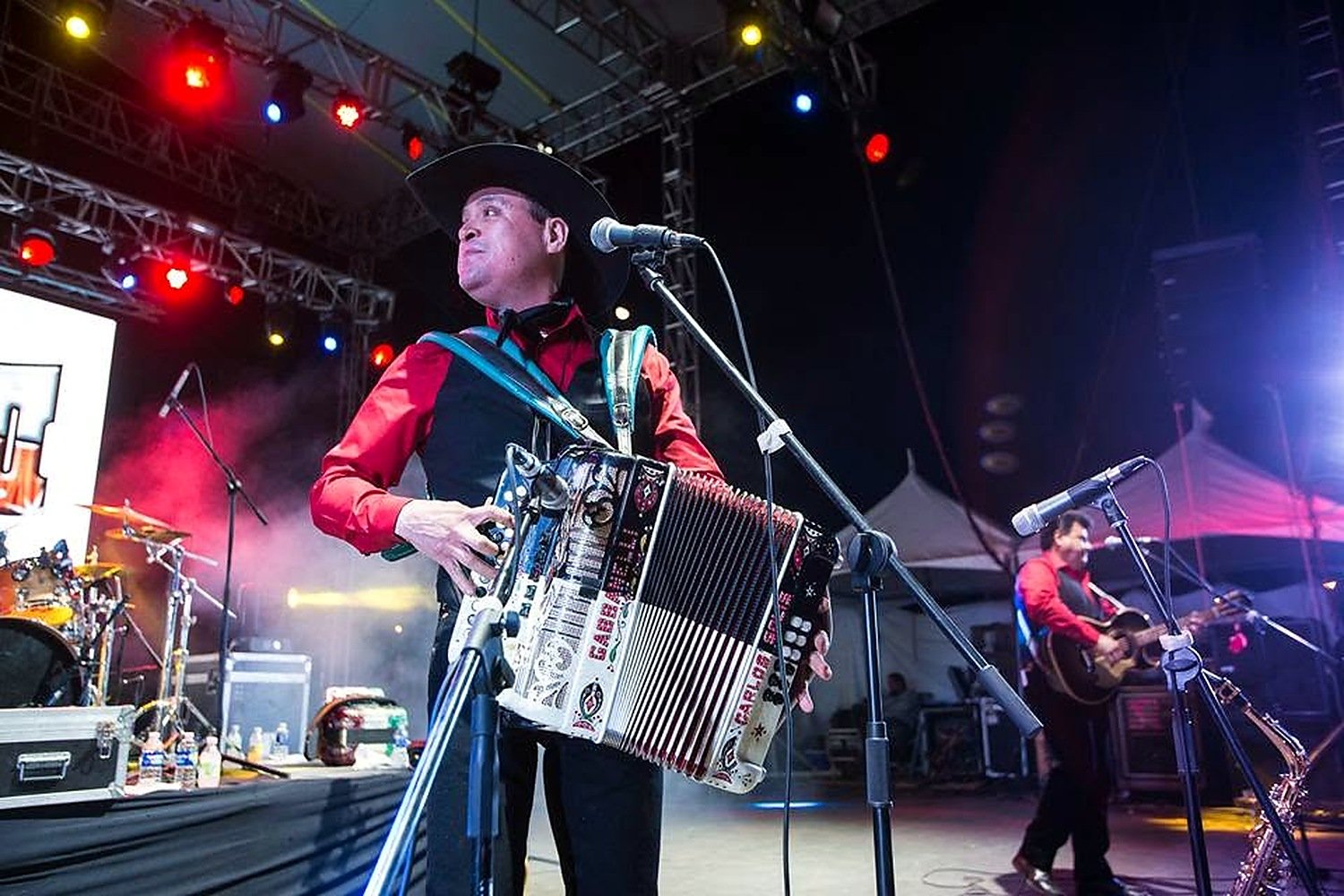 Carlos Solís performing on accordion onstage